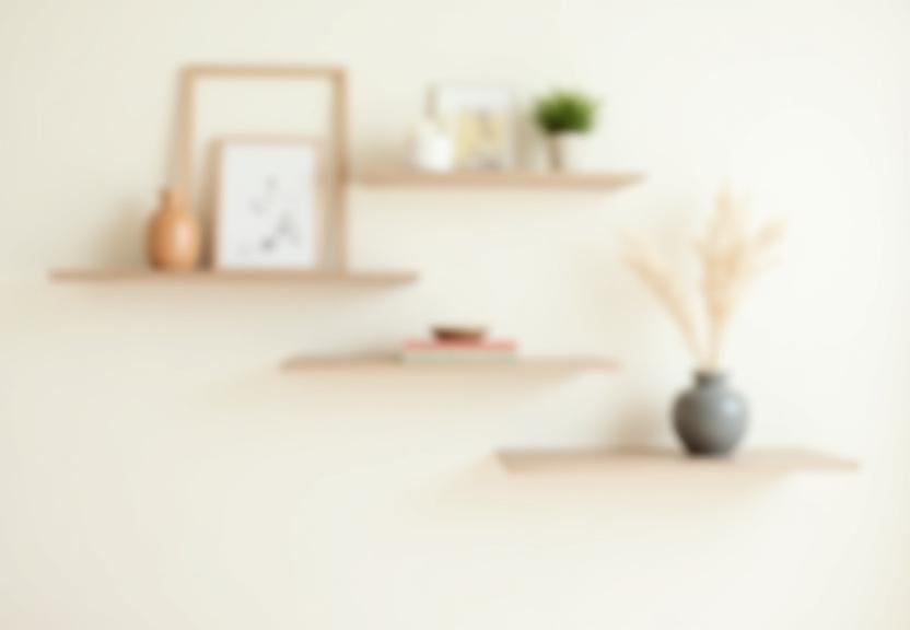 A set of three thick, floating ash wood shelves mounted on a wall.